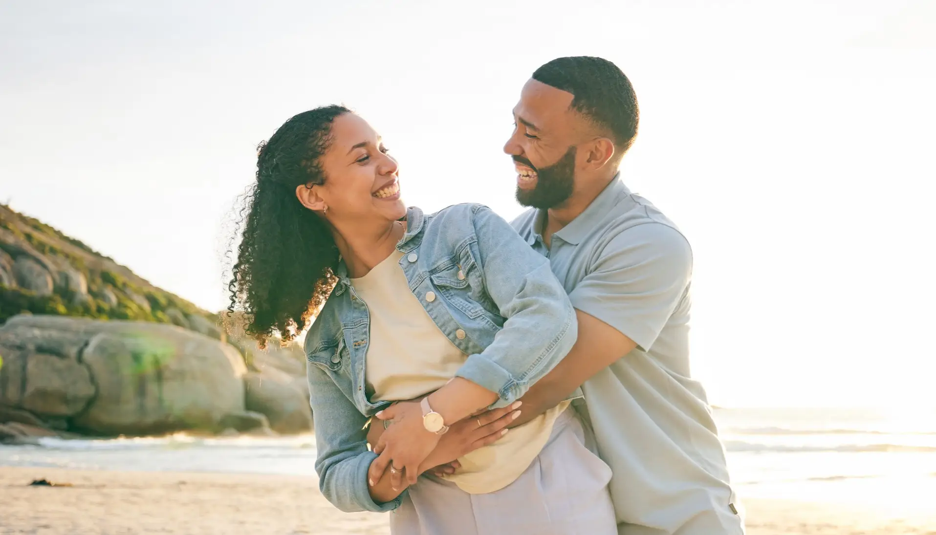 Couples Therapy. A happy couple smiling and hugging at the beach.