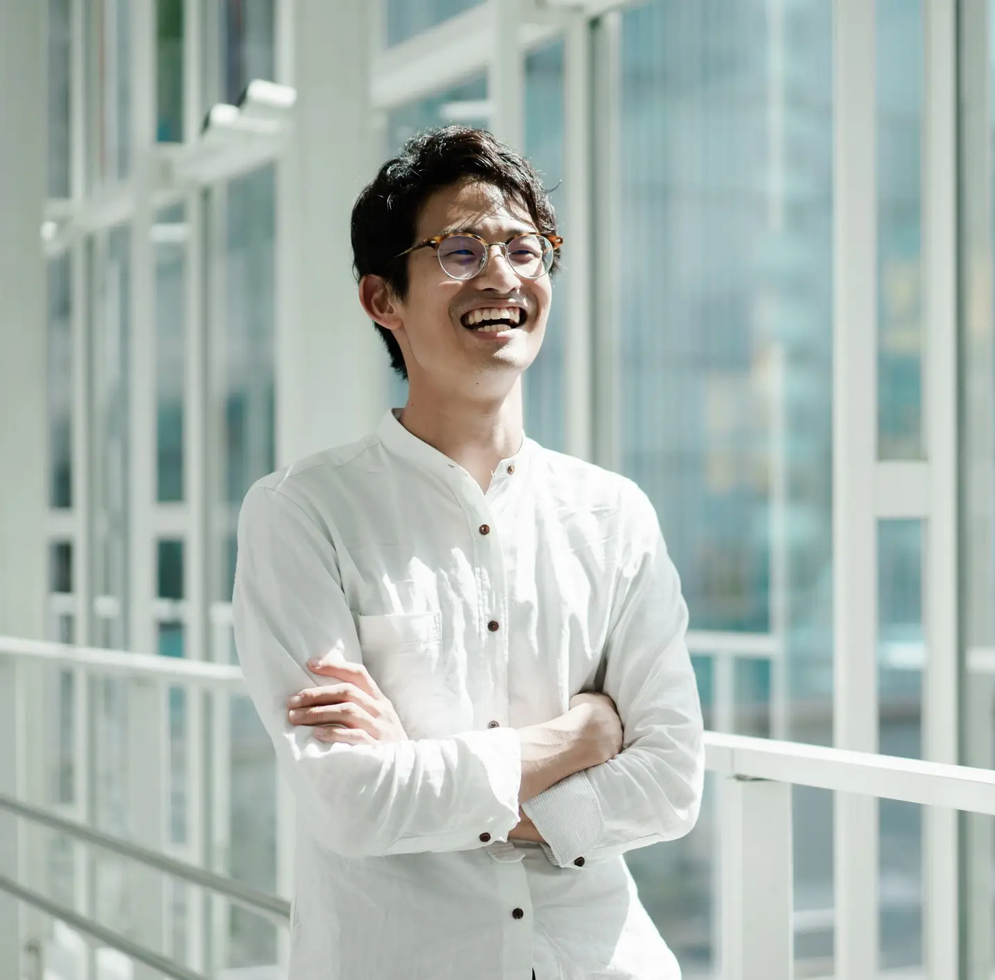 CBT Therapy. Casual business portrait of a young Asian man standing by the window. Looks like a CEO or engineer.