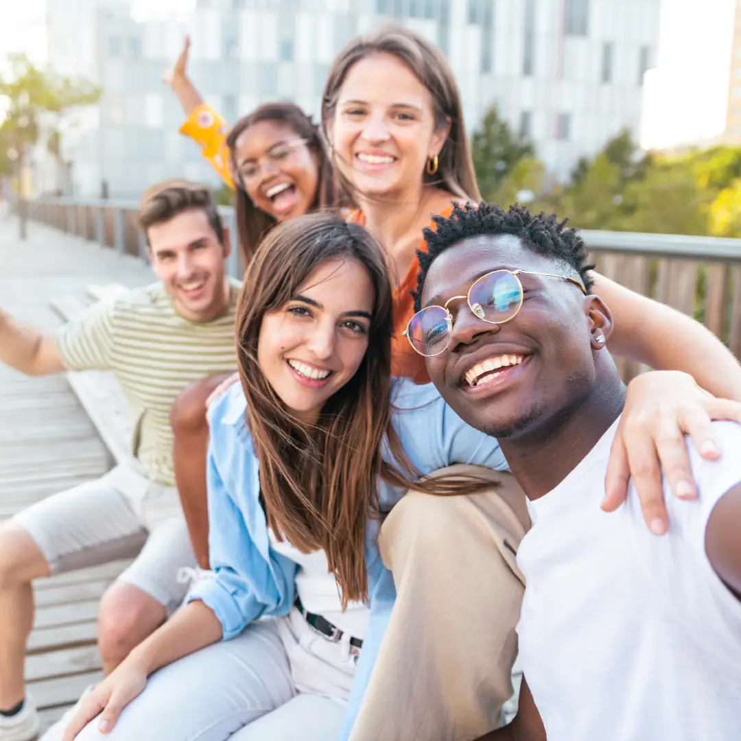 Anxiety Therapy. Happy friends sitting on bench taking a selfie