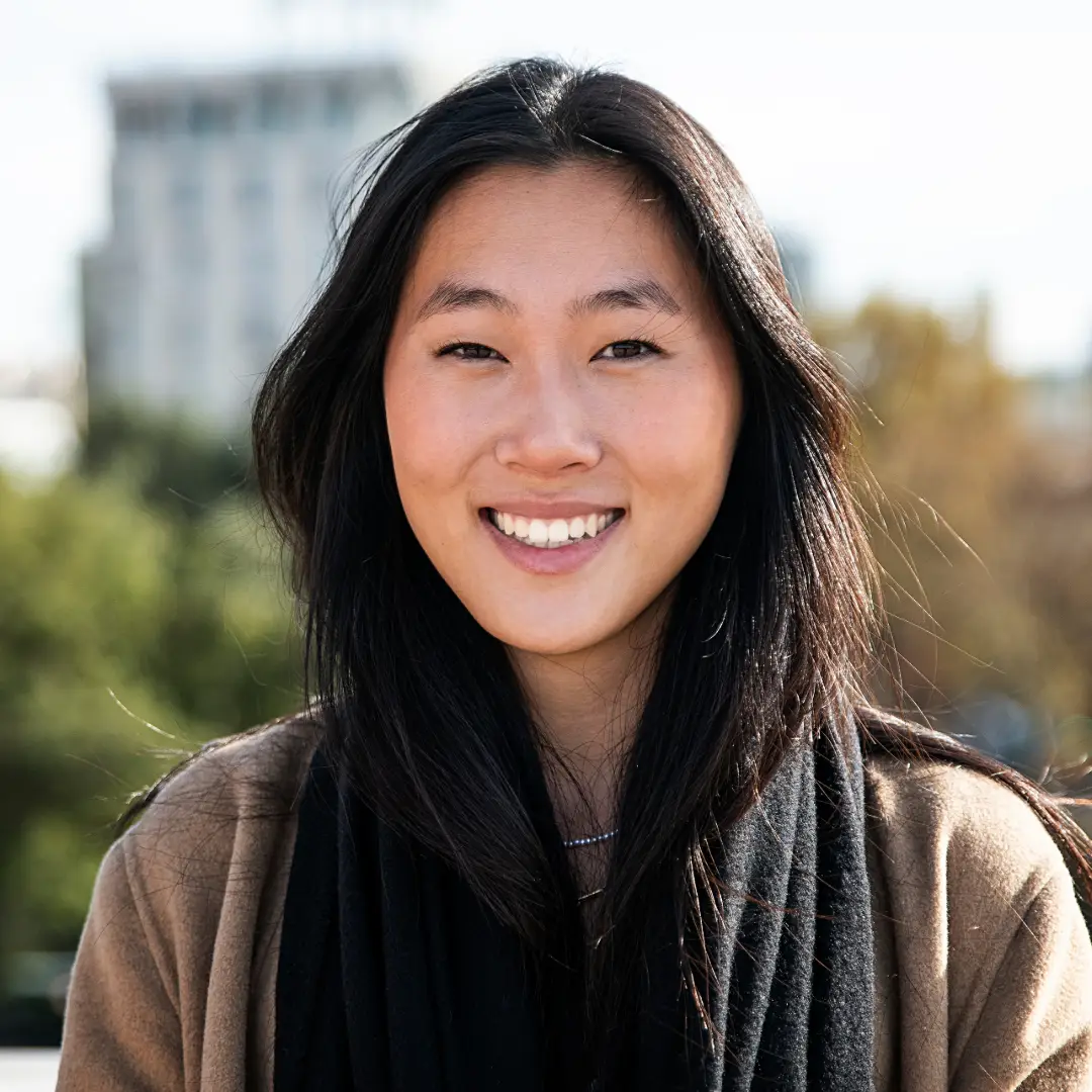 EMDR Therapy. Smiling East Asian woman with the view of a city behind her