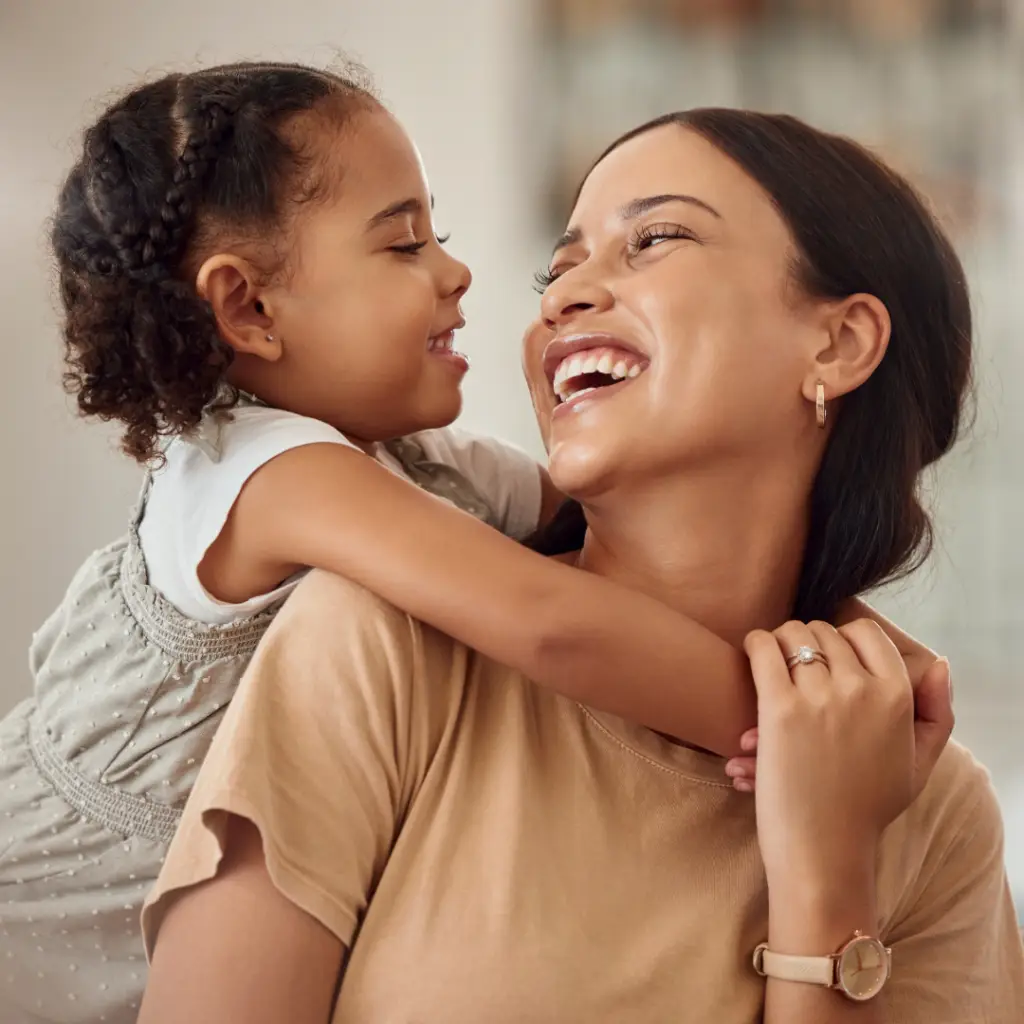ACT Therapy. Happy daughter hugging her smiling mother and laughing.
