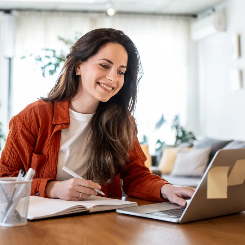 BFRB Therapy. Smiling woman working on her laptop