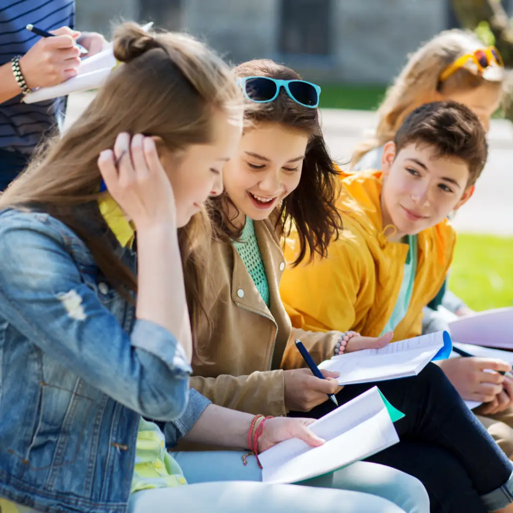 Child & Teen Therapy. Group of teenagers studying and collaborating outdoors