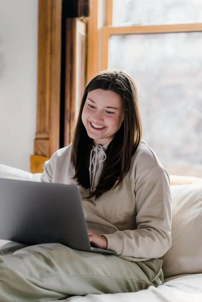 Woman using a laptop while sitting comfortably at home