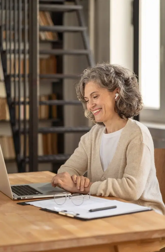 Woman attending a virtual nurse practitioner appointment from home using a laptop