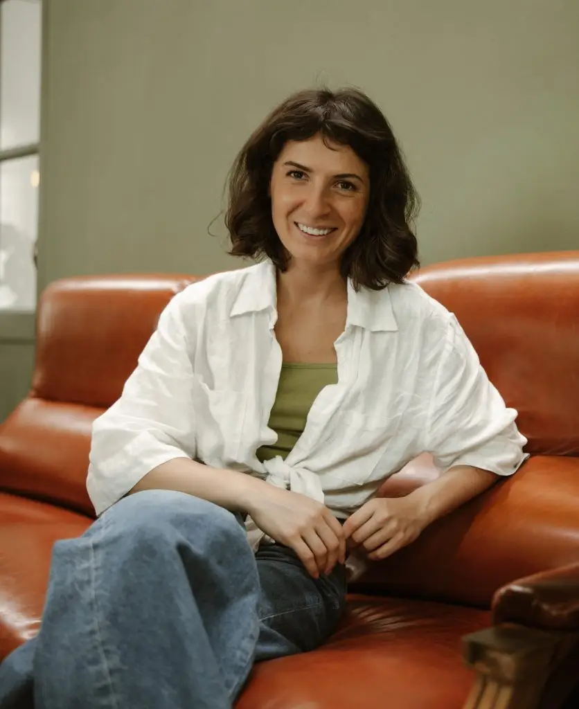 Woman sitting comfortably on a couch, representing supportive virtual Nurse Practitioner care in Ontario