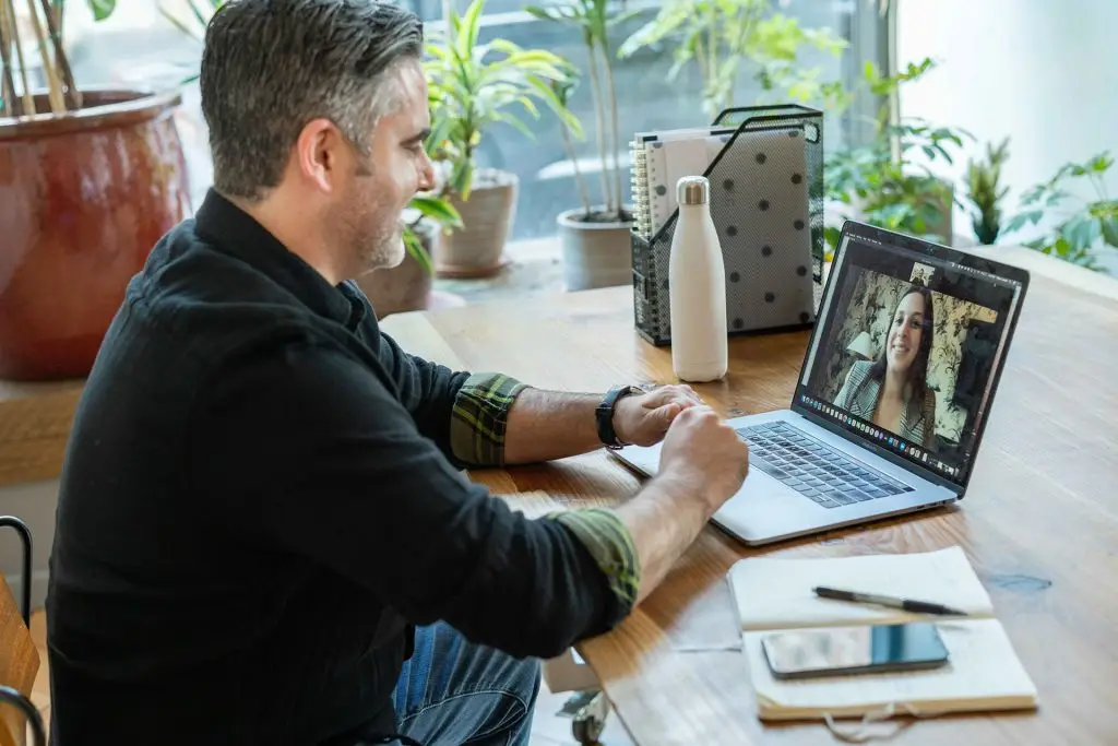 Man participating in an online therapy session from home